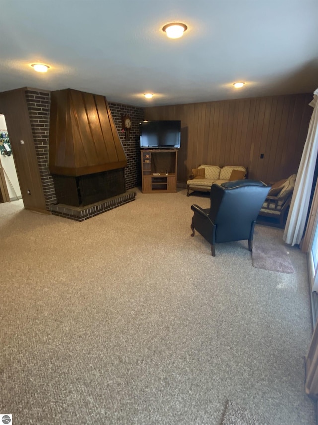 616 Holiday Dr, Bellaire, MI 49615 - carpeted living area with a fireplace and wooden walls