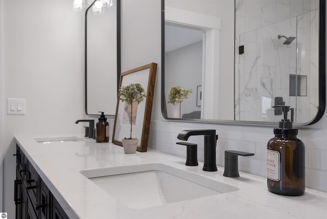 bathroom with a shower with door and vanity