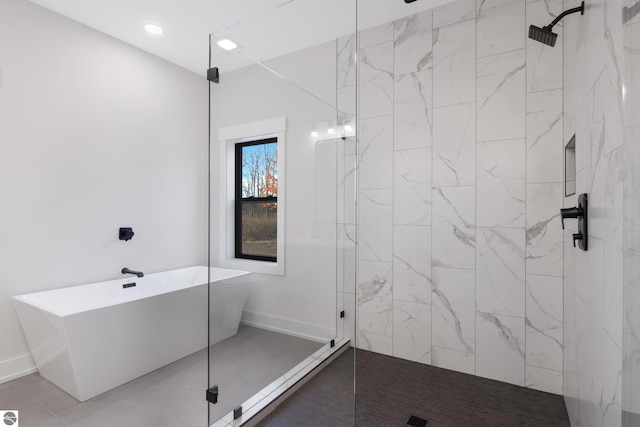 bathroom with tile patterned flooring and independent shower and bath