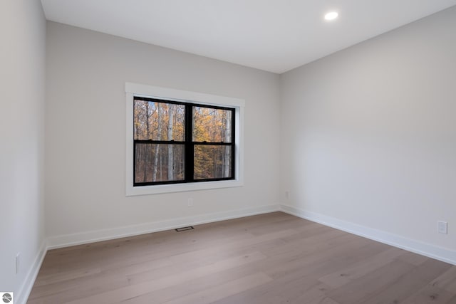 spare room featuring light wood-type flooring