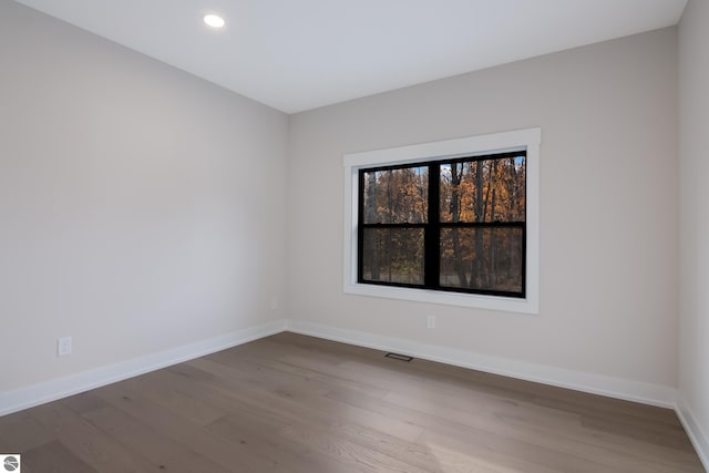 unfurnished room featuring hardwood / wood-style flooring