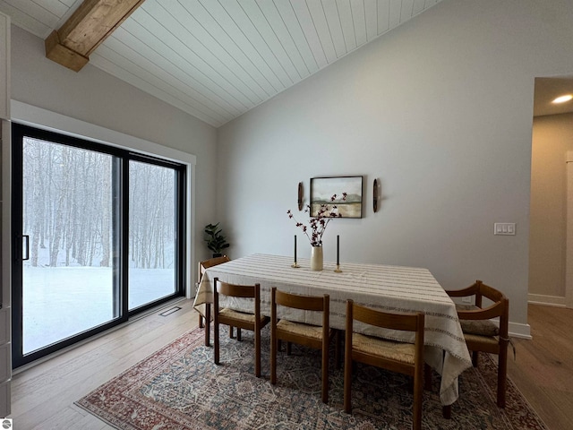 dining area with wood ceiling, vaulted ceiling, and hardwood / wood-style flooring