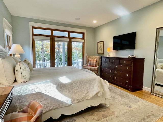 11320 Shippey Ln, Rapid City, MI 49676 - bedroom with recessed lighting, baseboards, access to exterior, and wood finished floors