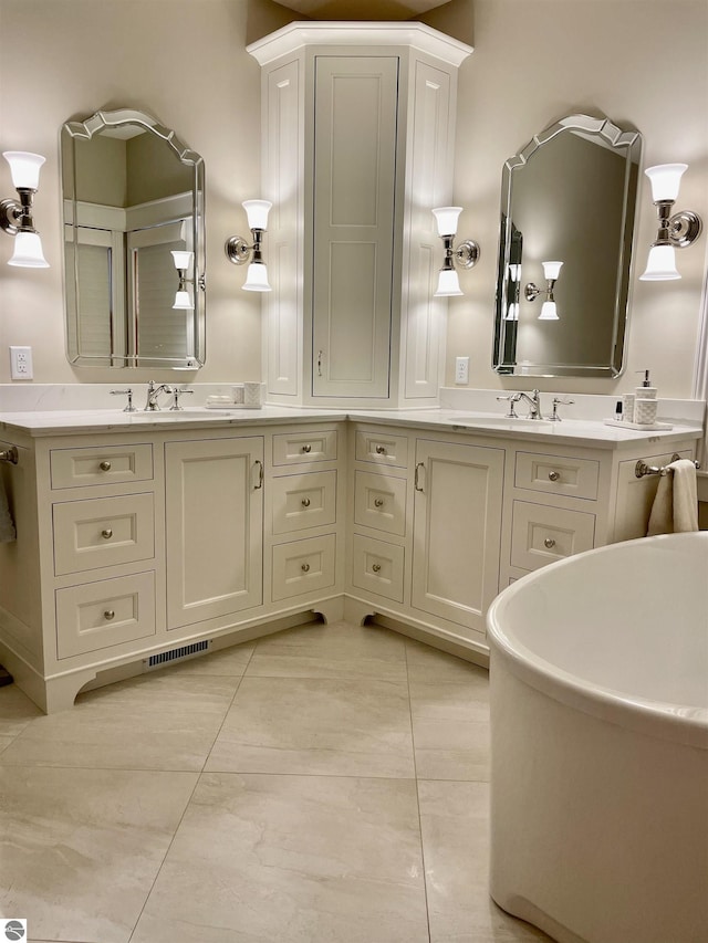 11320 Shippey Ln, Rapid City, MI 49676 - bathroom with vanity, tile patterned floors, and visible vents