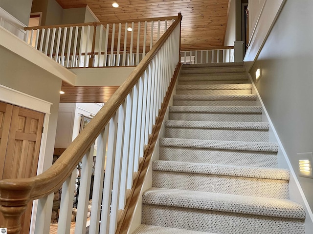 11320 Shippey Ln, Rapid City, MI 49676 - staircase with carpet flooring, a high ceiling, recessed lighting, baseboards, and wood ceiling