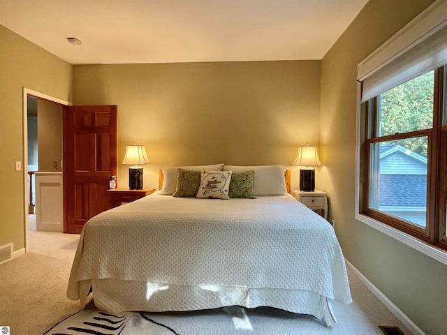 bedroom featuring light colored carpet