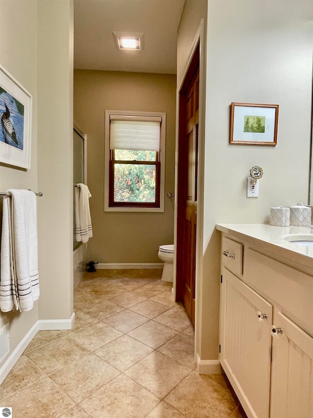 bathroom featuring vanity, tile patterned floors, toilet, and walk in shower