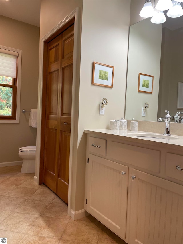 bathroom with vanity, toilet, and tile patterned flooring