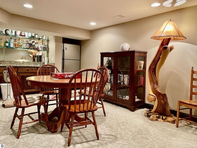 11320 Shippey Ln, Rapid City, MI 49676 - dining area with recessed lighting, light carpet, and indoor bar