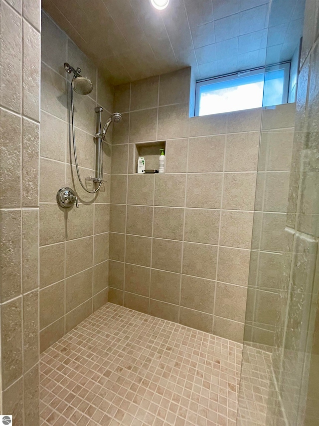 bathroom with a tile shower