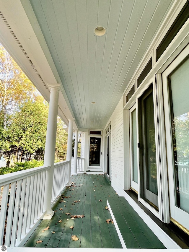 11320 Shippey Ln, Rapid City, MI 49676 - wooden terrace with covered porch