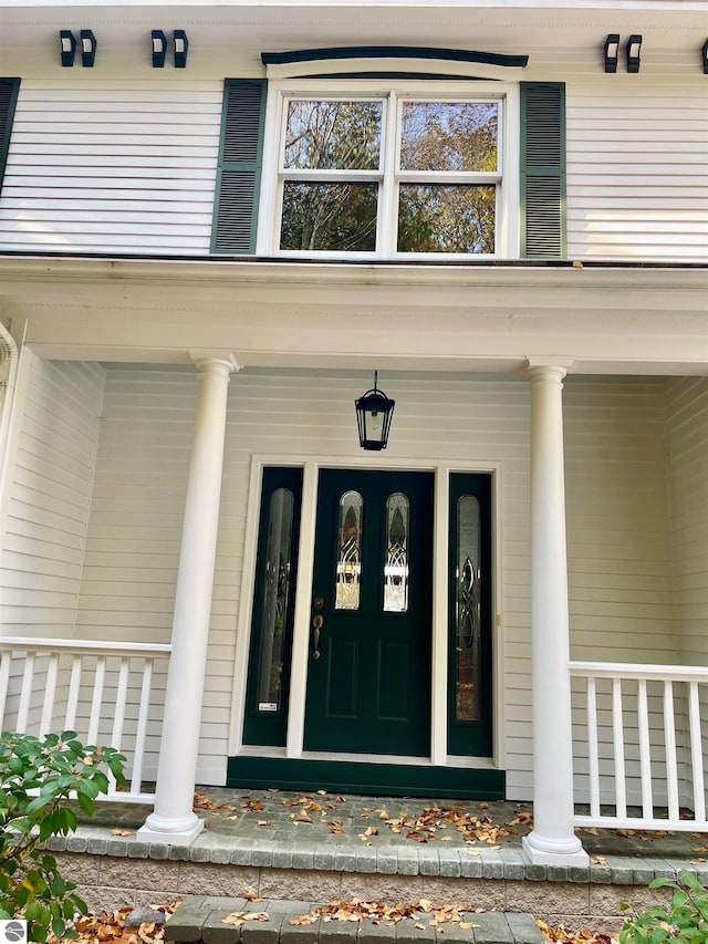 doorway to property featuring covered porch