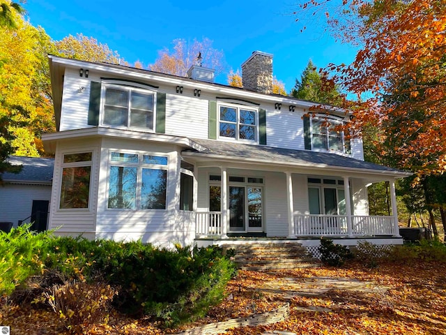 back of property with a porch