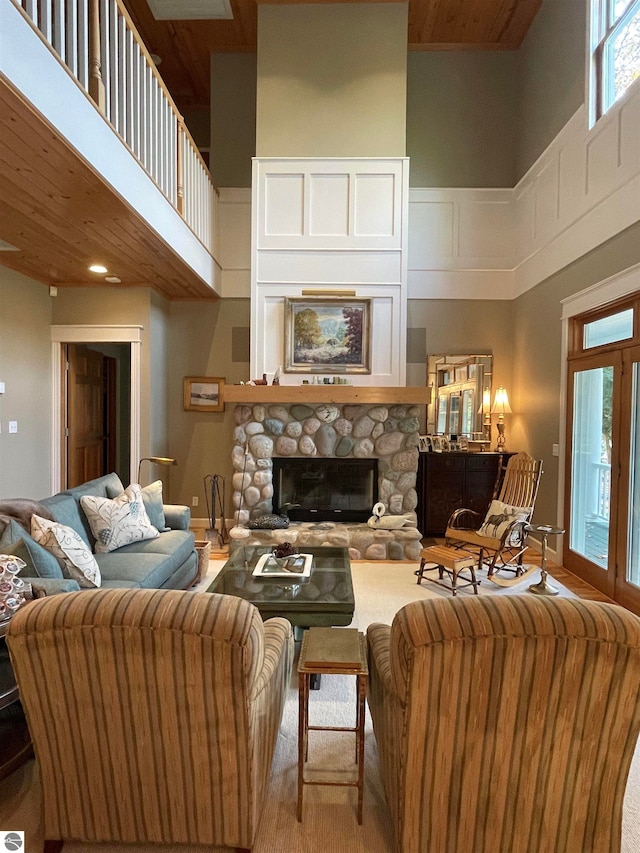 living room featuring a high ceiling and a fireplace