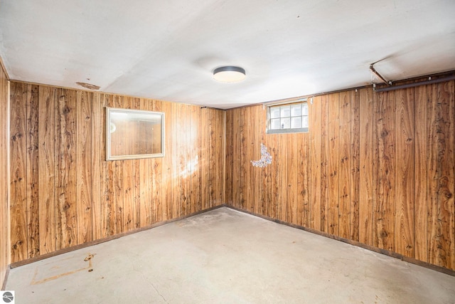 spare room featuring wood walls