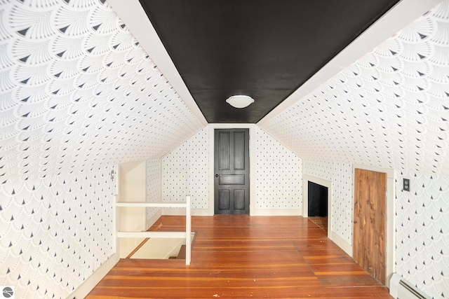 bonus room featuring lofted ceiling, hardwood / wood-style floors, and a baseboard radiator