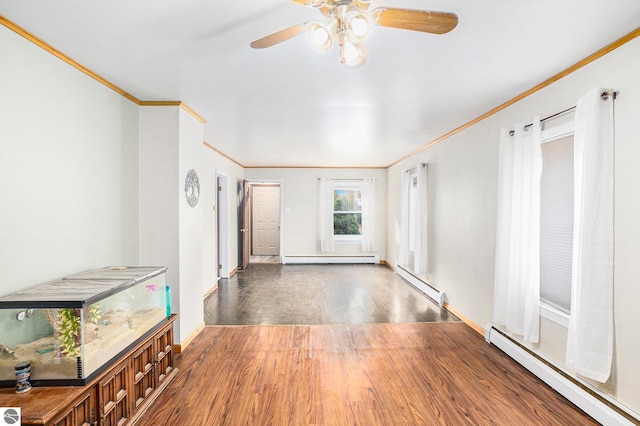 interior space with crown molding, a baseboard heating unit, dark hardwood / wood-style floors, and ceiling fan