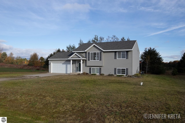 view of front of house featuring a garage and a front lawn