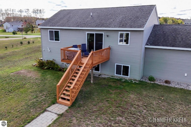 back of property with a yard and a deck