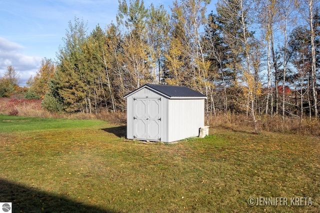 view of outbuilding featuring a lawn