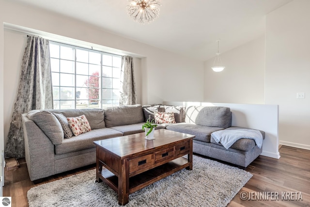 living room with vaulted ceiling and dark hardwood / wood-style flooring