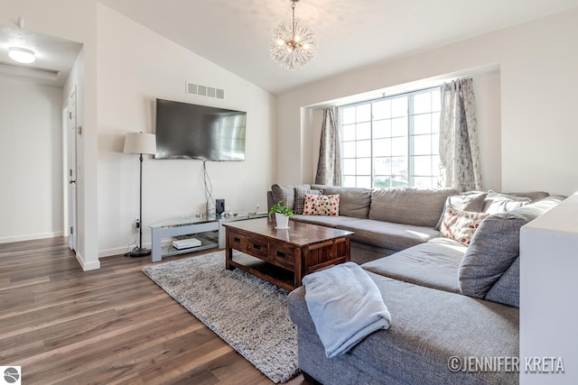 living room featuring a notable chandelier, hardwood / wood-style flooring, and vaulted ceiling