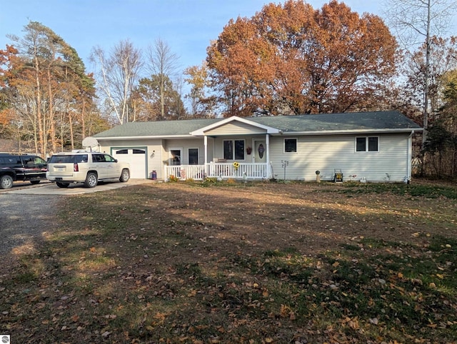 single story home with a porch and a garage