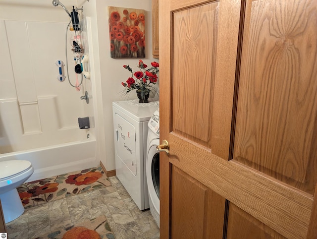 bathroom featuring toilet, independent washer and dryer, and bathing tub / shower combination