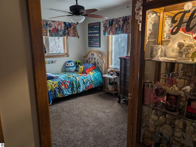 bedroom with ceiling fan, crown molding, and carpet floors