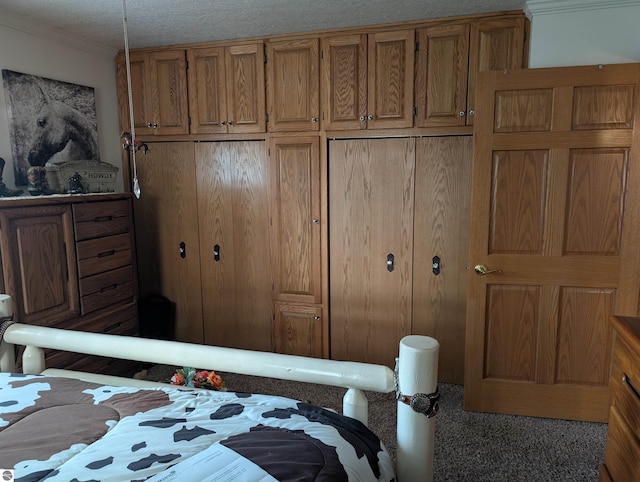 bedroom featuring a textured ceiling and carpet floors