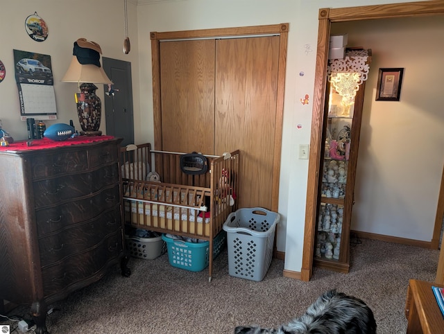 bedroom with a closet, carpet floors, and a crib