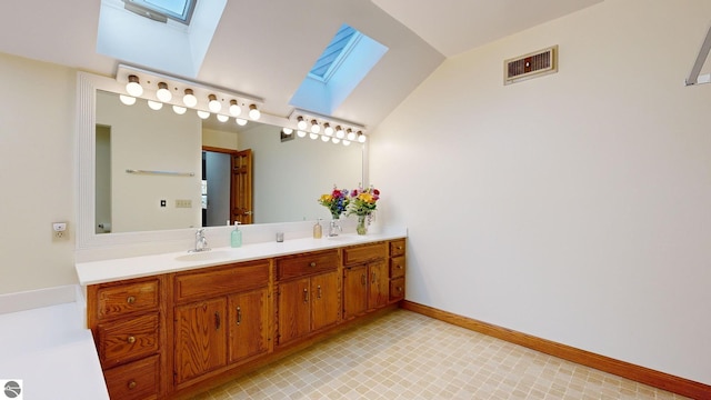 bathroom featuring vanity and lofted ceiling with skylight