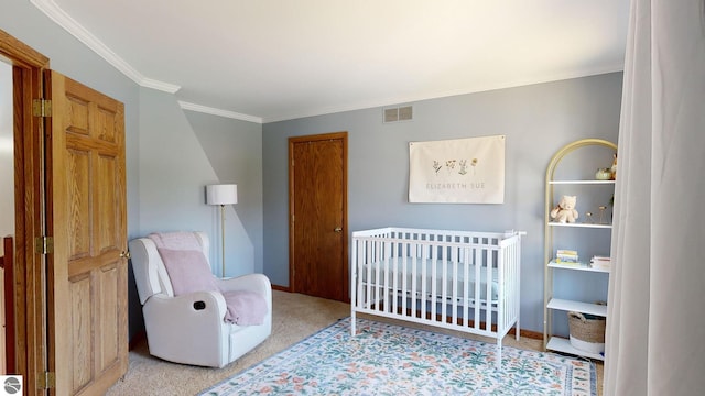 bedroom with ornamental molding, light colored carpet, and a crib