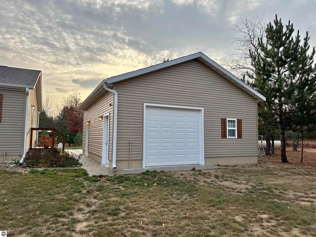 garage at dusk with a yard