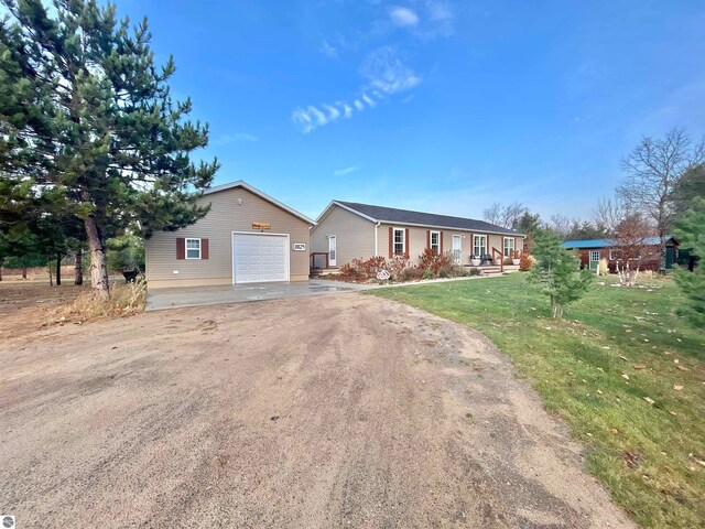 single story home featuring a front yard and a garage