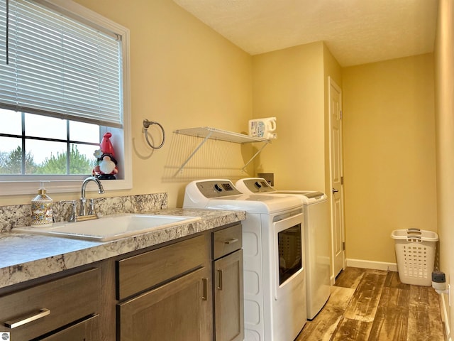 washroom with sink, a textured ceiling, hardwood / wood-style flooring, and separate washer and dryer