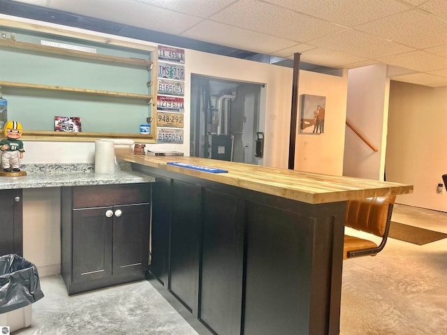 bar with a drop ceiling and butcher block counters