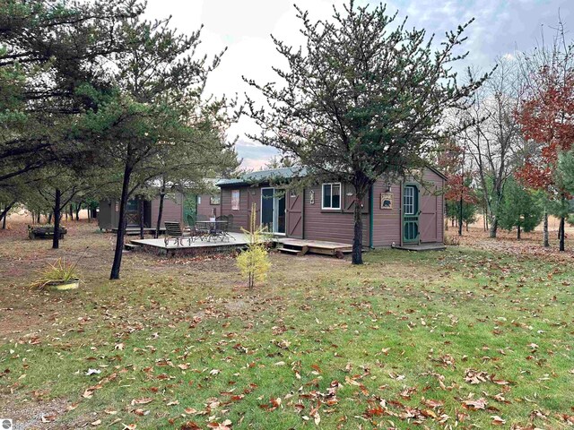 view of yard featuring a deck and an outbuilding