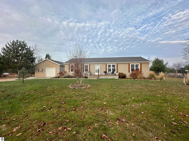 ranch-style home with an outbuilding and a front lawn