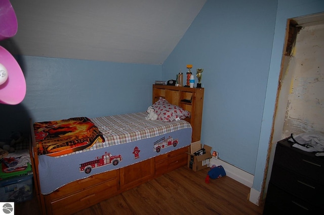 bedroom featuring lofted ceiling and hardwood / wood-style floors