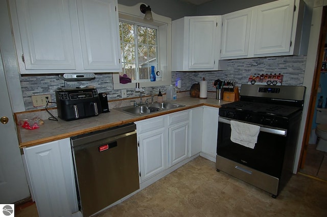 kitchen featuring sink, white cabinetry, decorative backsplash, and stainless steel appliances