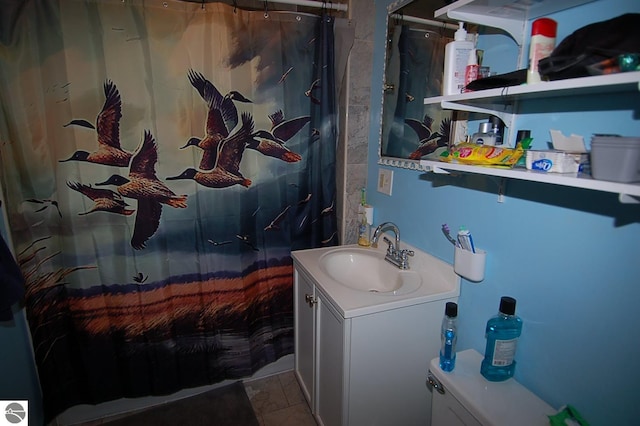 bathroom featuring vanity, a shower with curtain, toilet, and tile patterned flooring