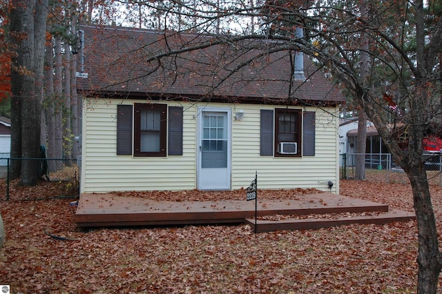 view of front facade with cooling unit and a wooden deck