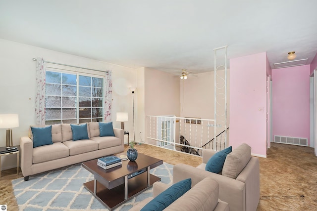 living room featuring light carpet and ceiling fan