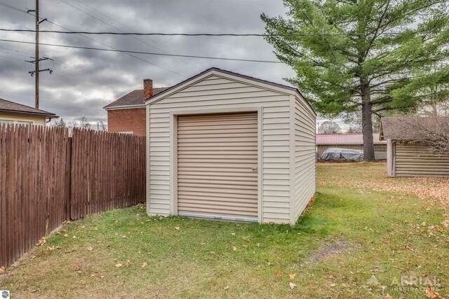 view of shed featuring fence