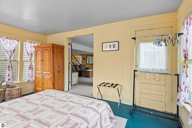 carpeted bedroom with multiple windows