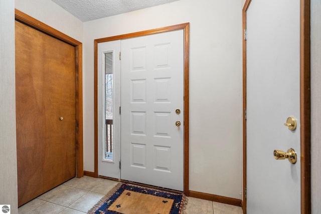 tiled entrance foyer with a healthy amount of sunlight and a textured ceiling