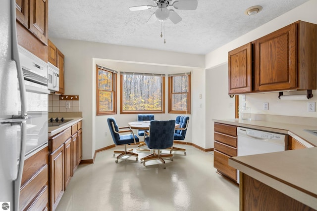 kitchen featuring a textured ceiling, backsplash, ceiling fan, and white appliances