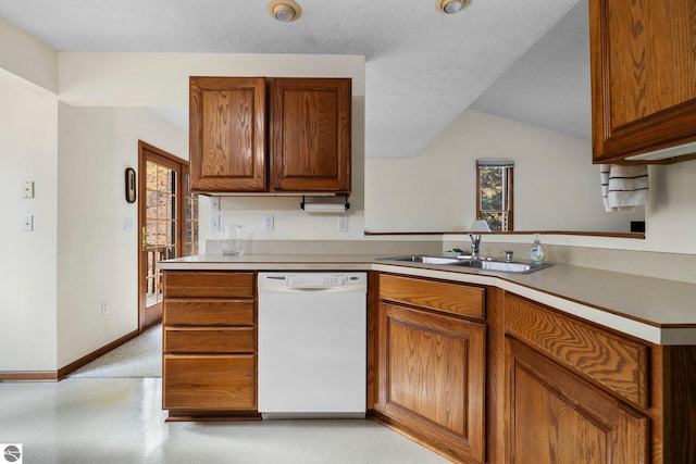 kitchen with white dishwasher, kitchen peninsula, sink, and a textured ceiling