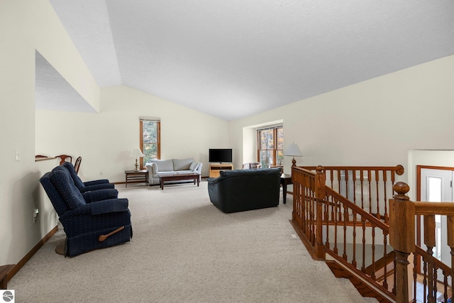 carpeted living room featuring vaulted ceiling